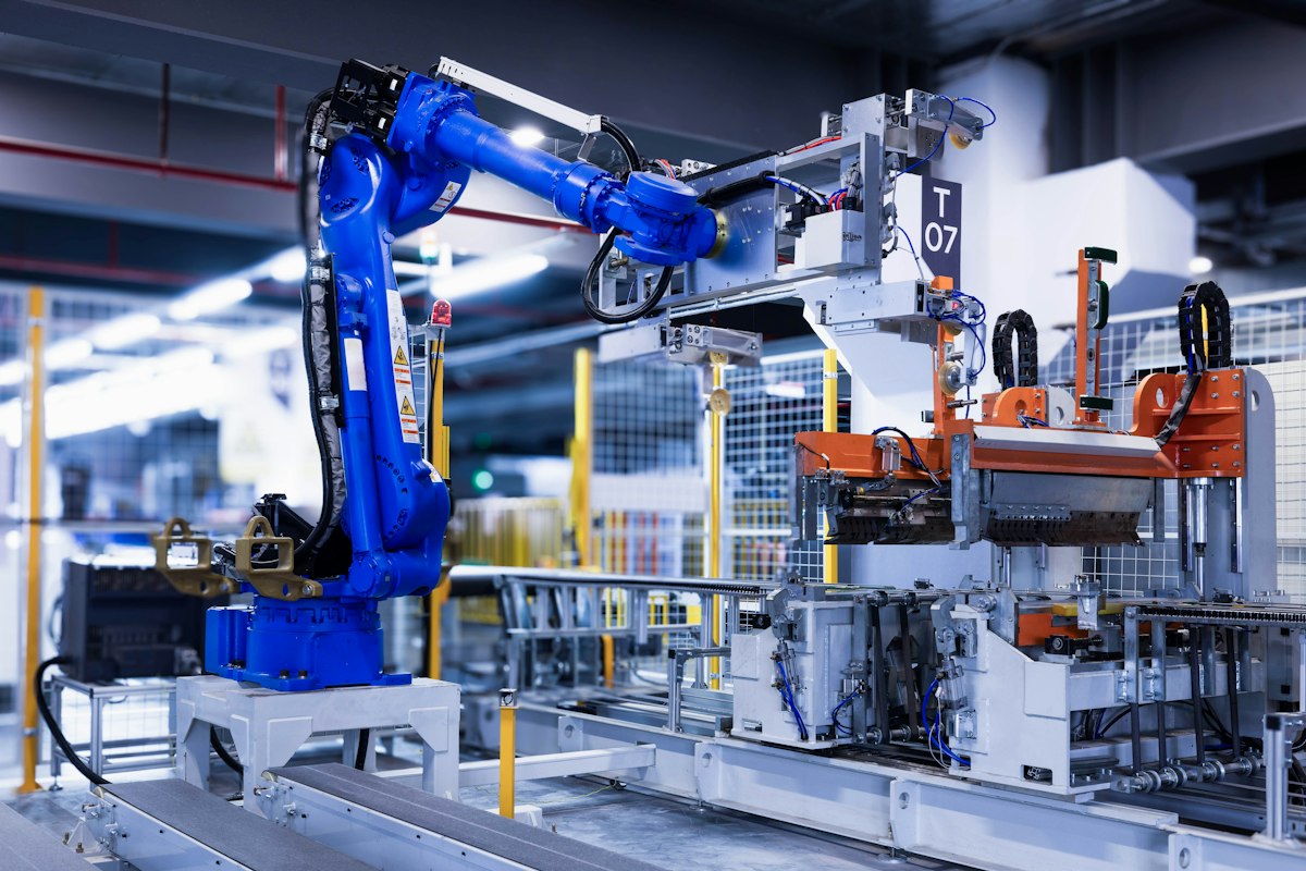 Blue industrial robot arm in an automated manufacturing cell
